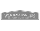 Woodminster property management logo.